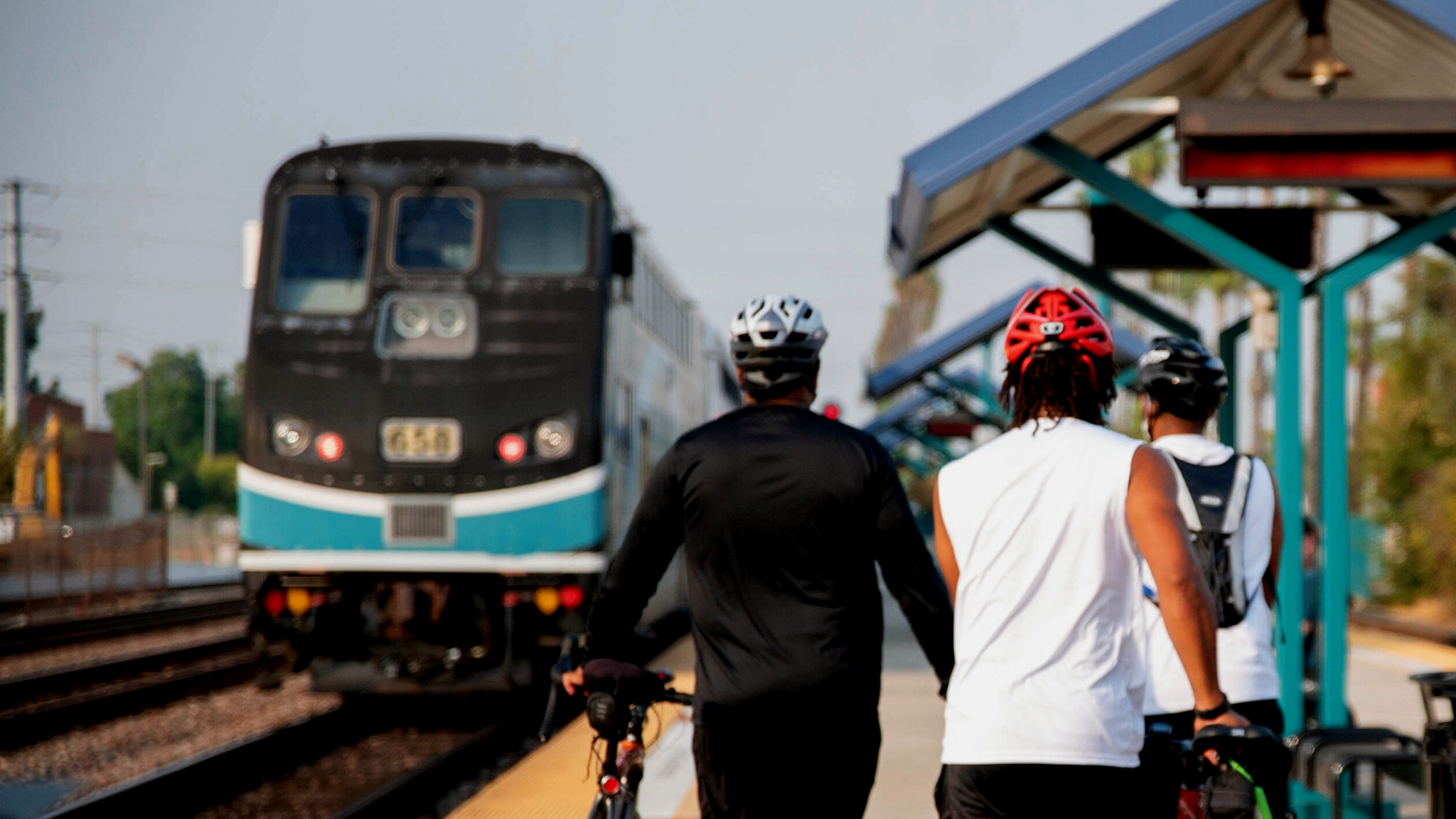 Metrolink train approaching with cyclists in the forefront